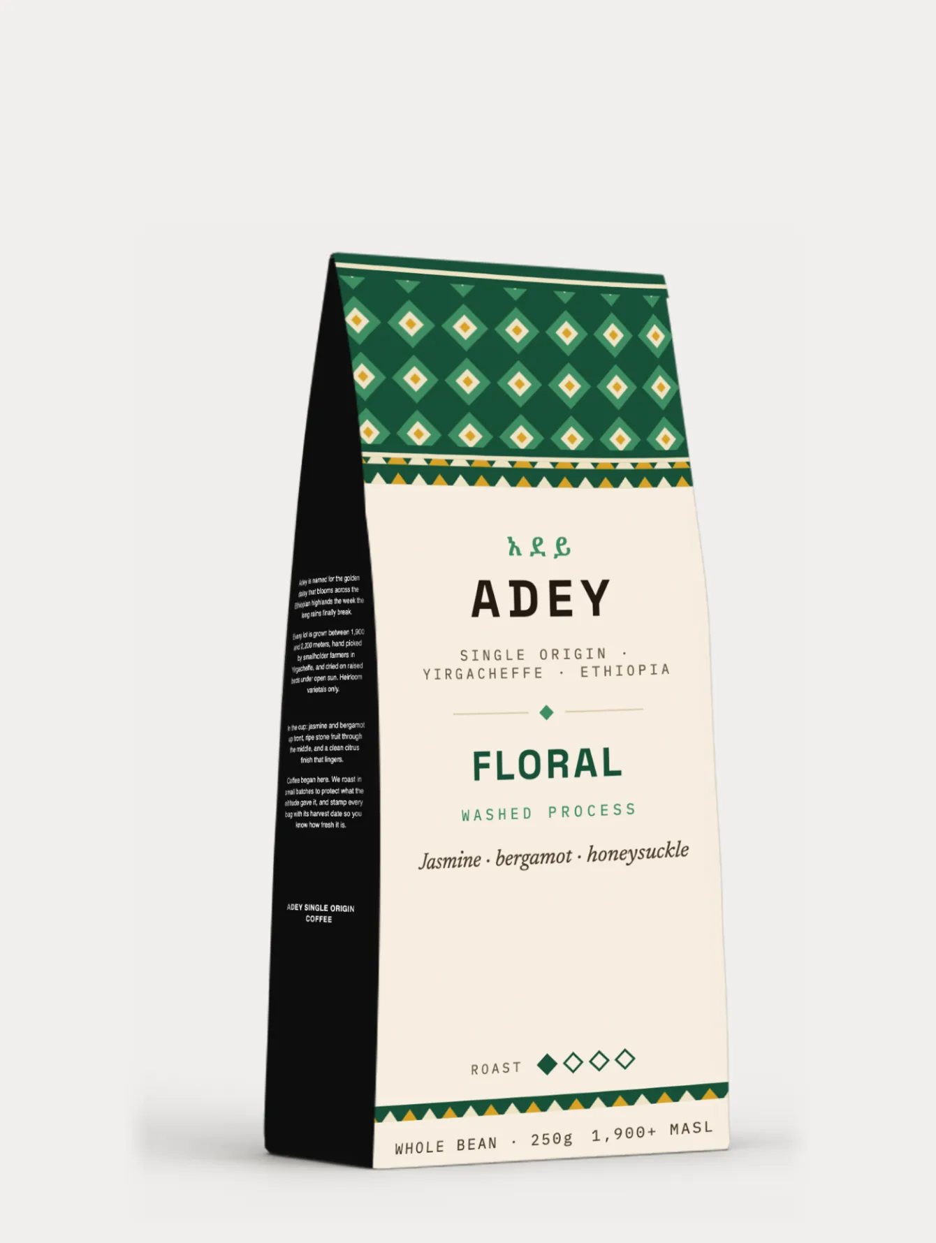 The Floral bag: a deep green woven pattern band above a cream label with the Amharic and Latin Adey lockup and the notes jasmine, bergamot, honeysuckle