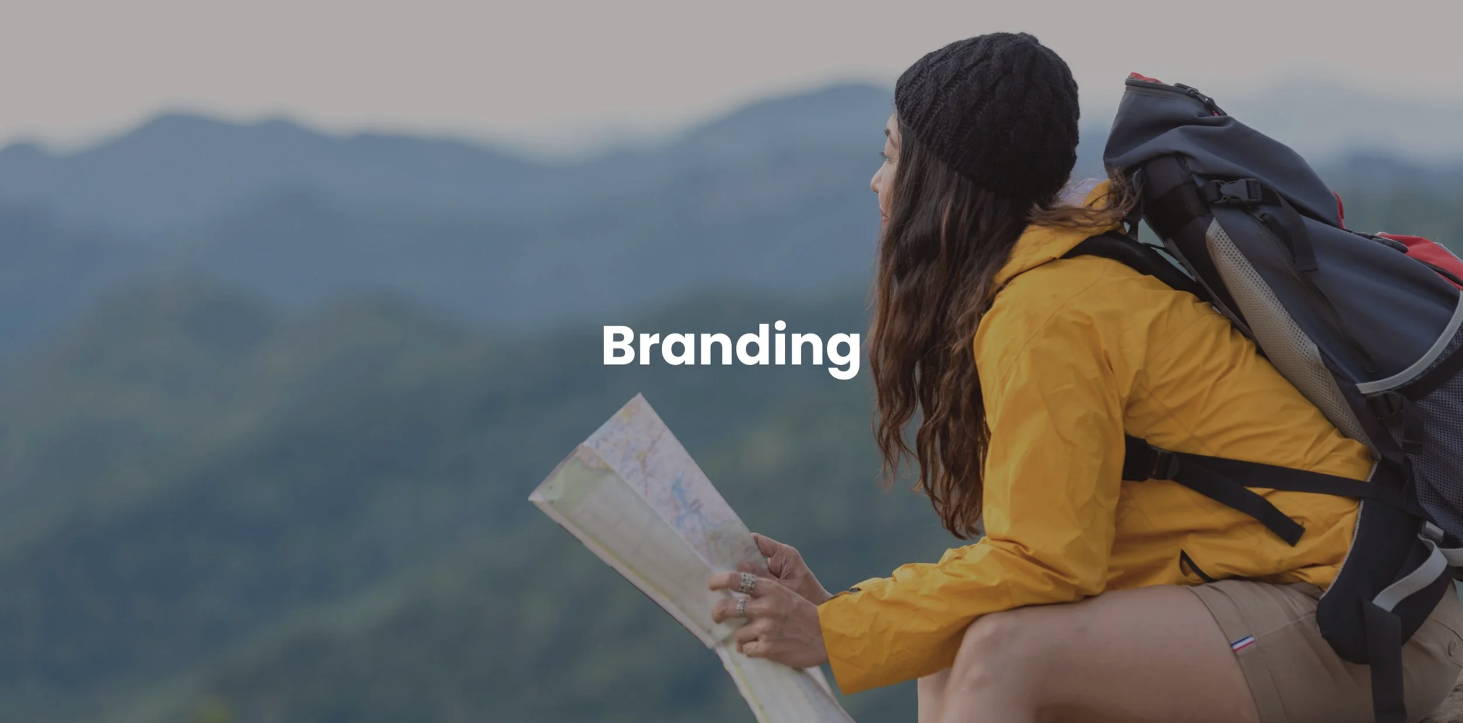 Branding section title over a woman reading a map on a mountain trail